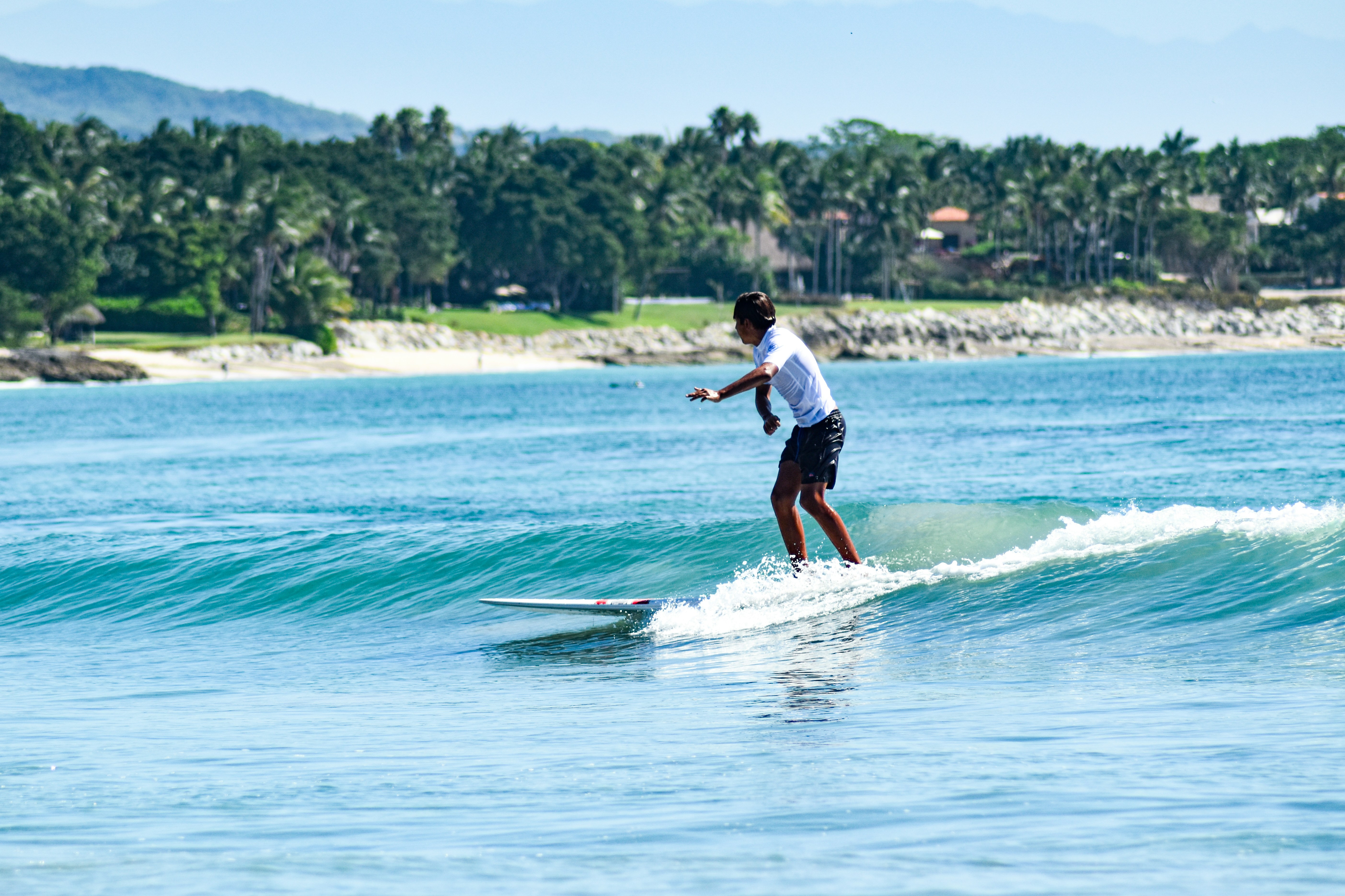 a man riding a wave on top of a surfboard