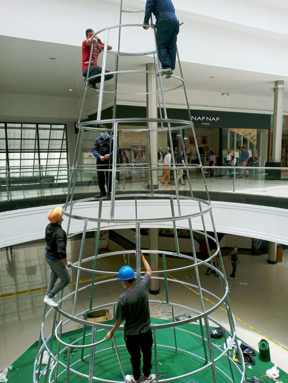 a group of people standing on top of a metal structure