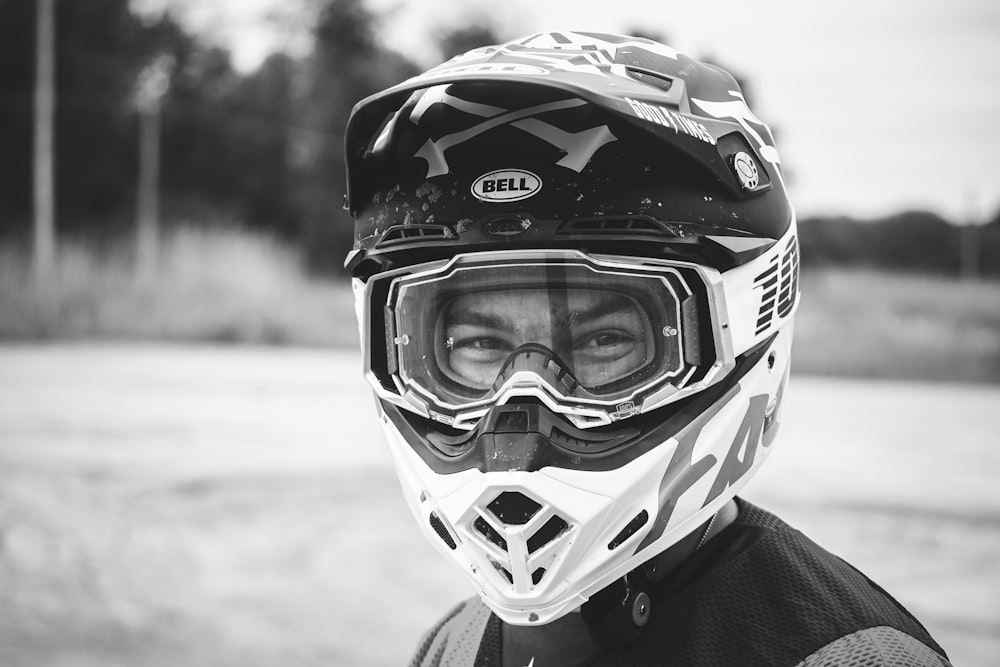 a black and white photo of a person wearing a helmet