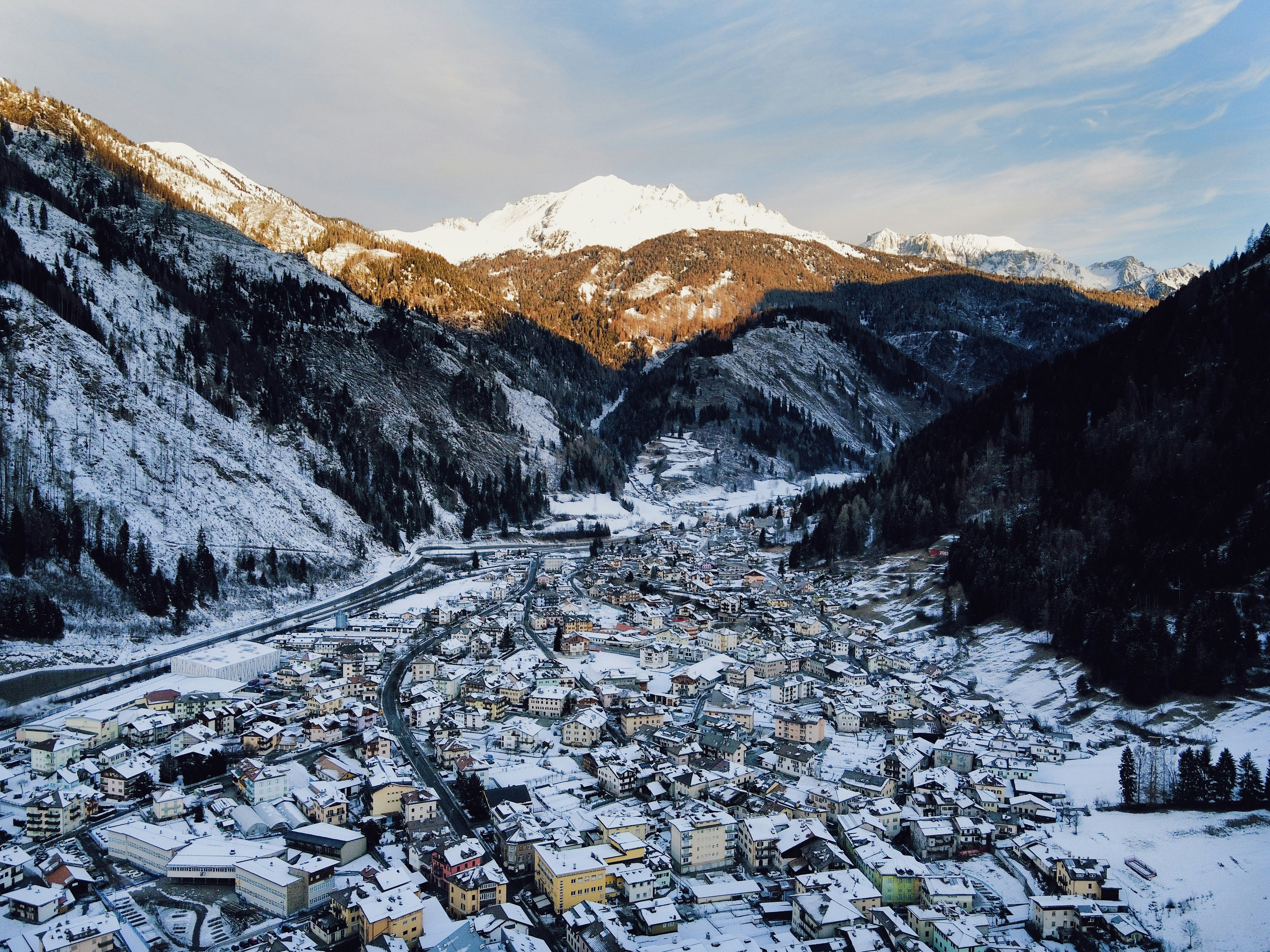 a snowy mountain town surrounded by trees and mountains