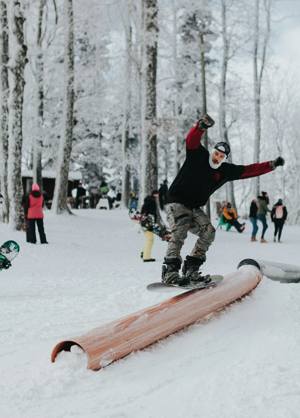 a man riding a snowboard down a snow covered slope