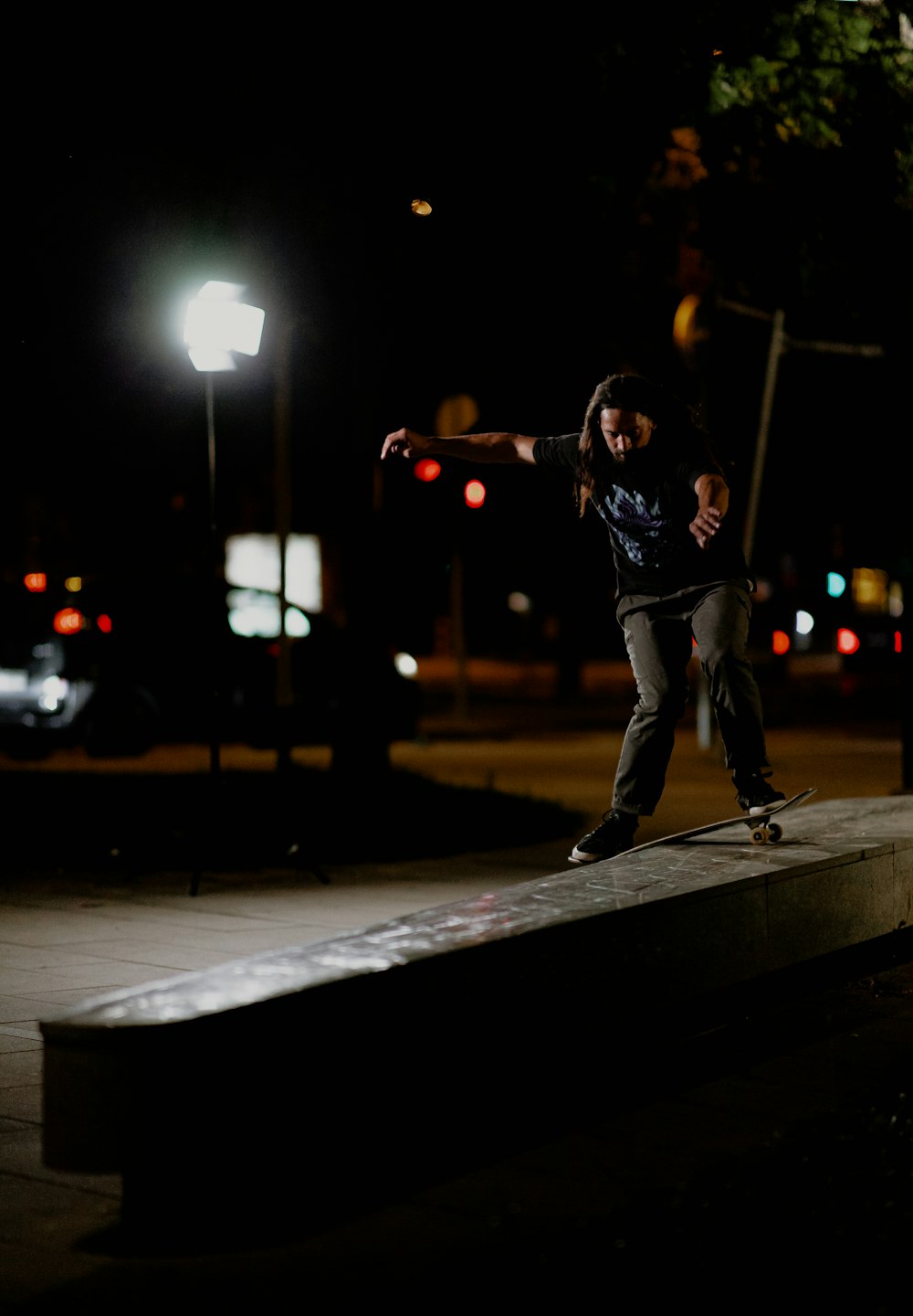 a man riding a skateboard down the side of a sidewalk