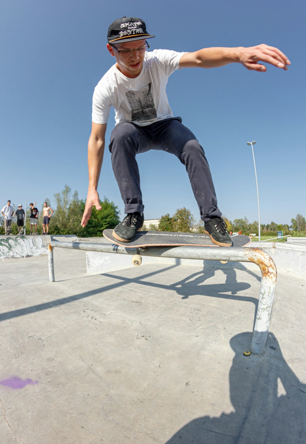 a man riding a skateboard on top of a metal rail