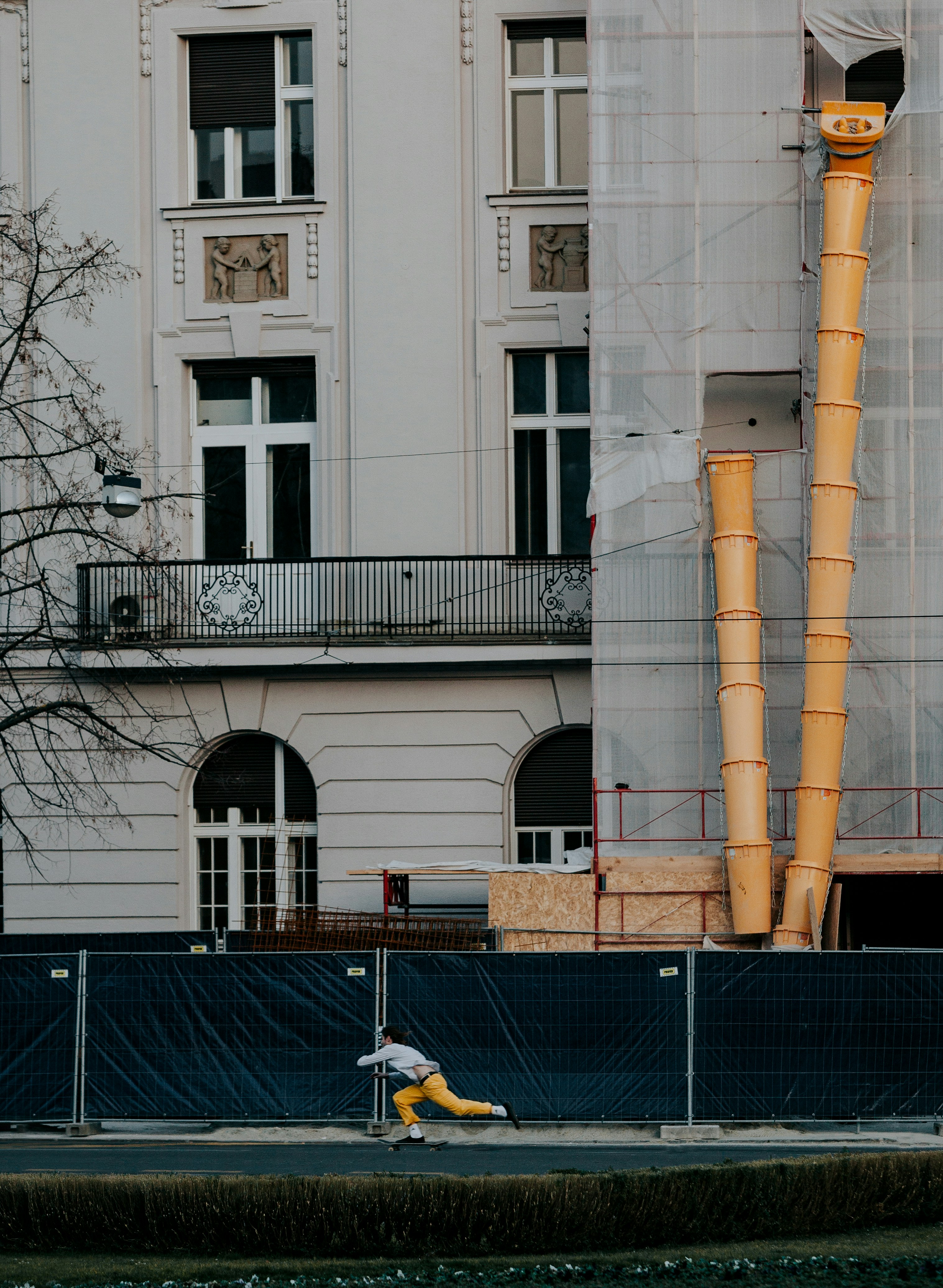 a man riding a skateboard down a street next to a tall building