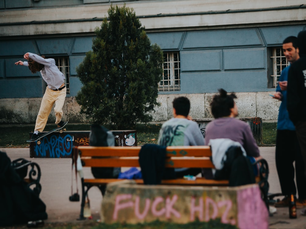 a man riding a skateboard down the side of a wooden bench