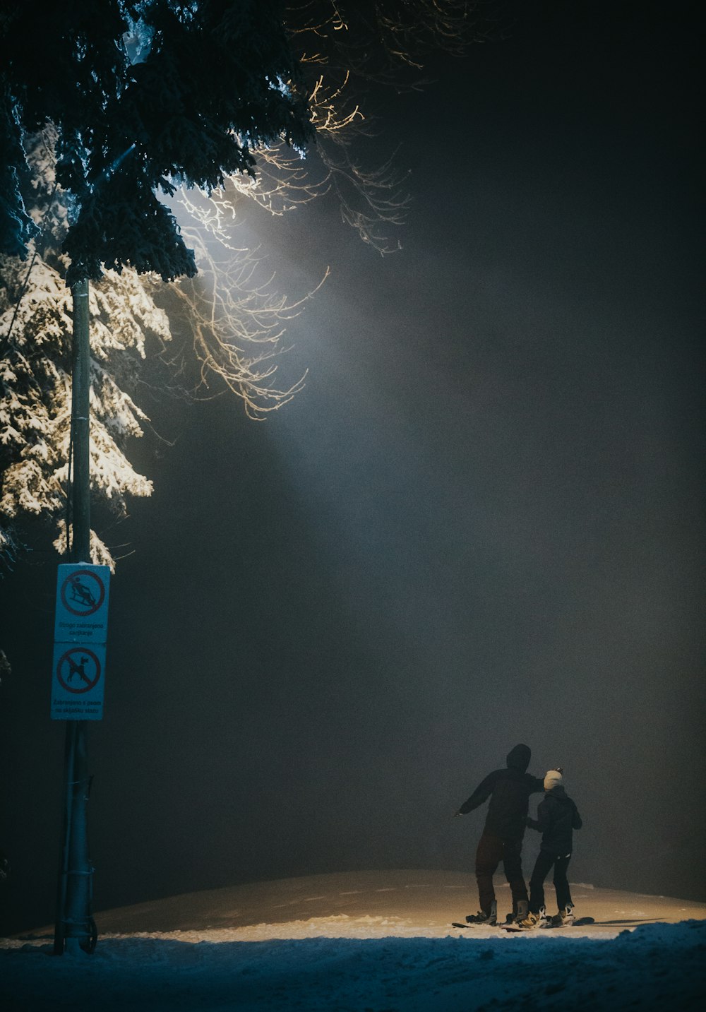 a couple of people that are standing in the snow