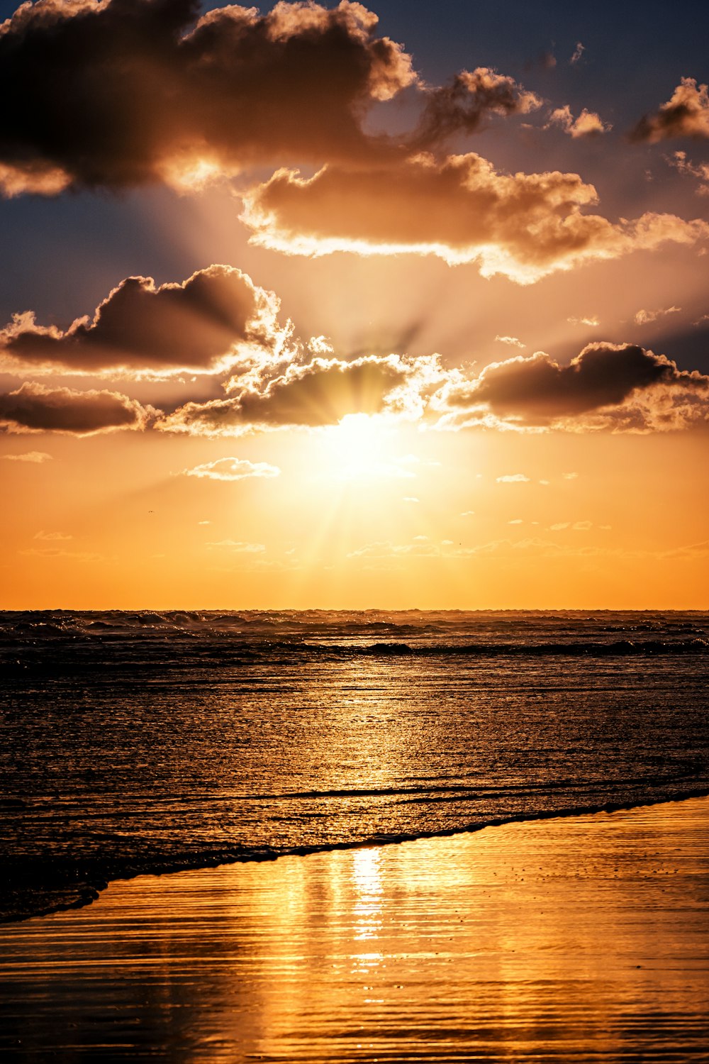 the sun is shining through the clouds over the ocean