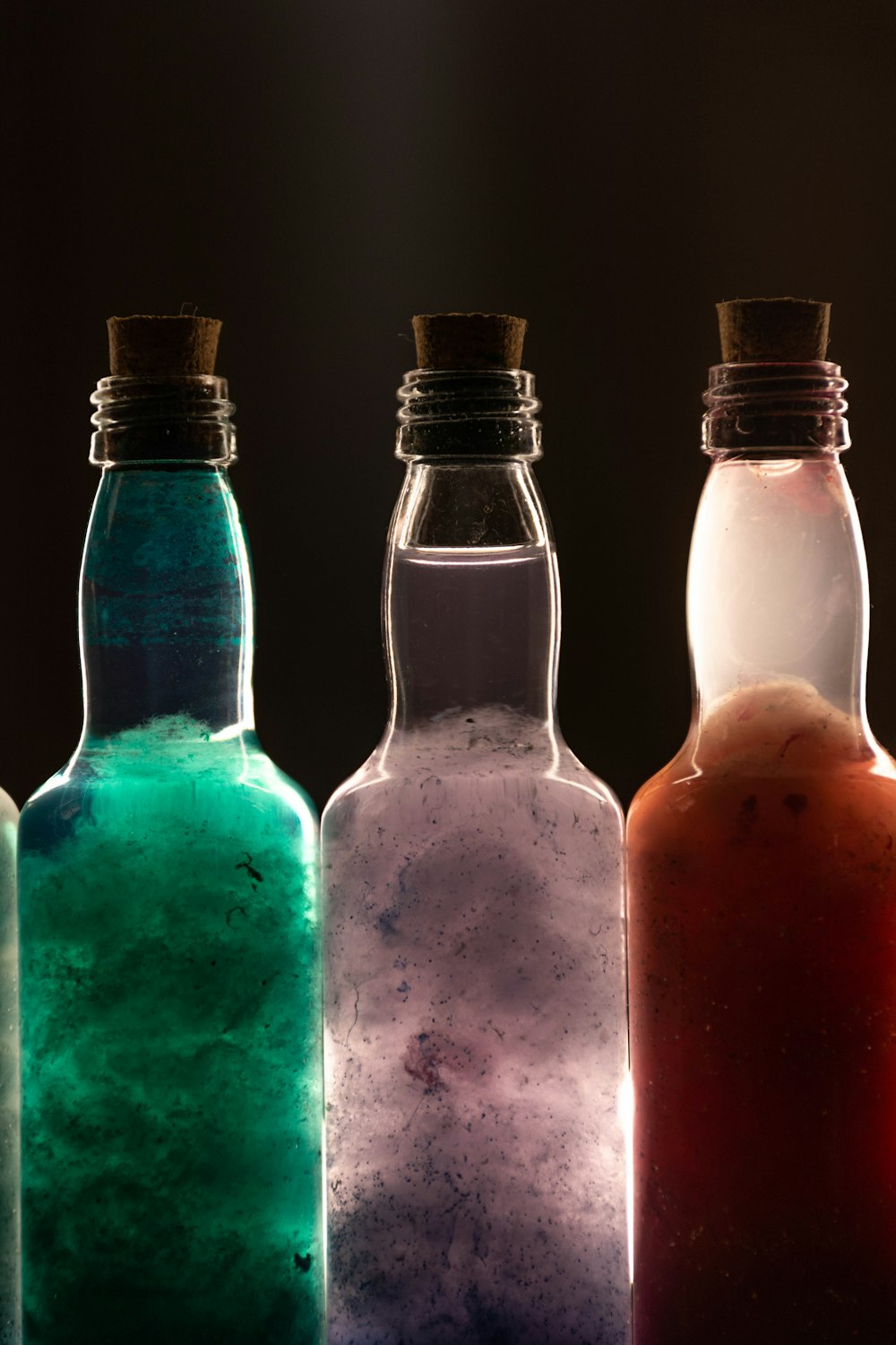 a row of glass bottles filled with liquid