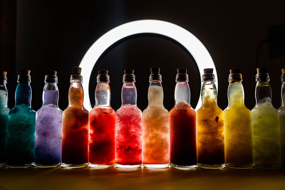 a group of bottles filled with different colored liquid