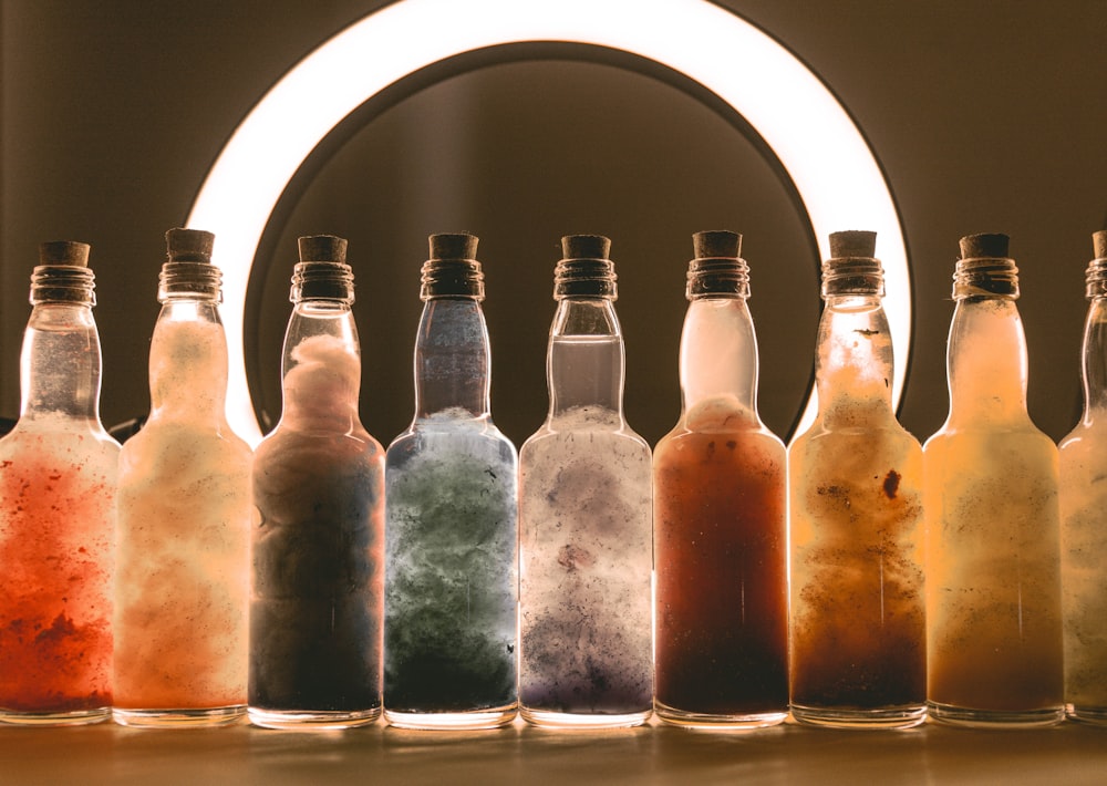 a row of bottles filled with different colored liquids