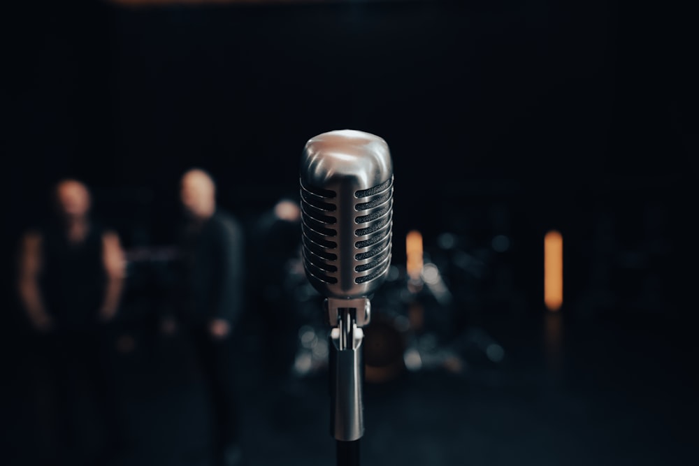 a microphone with a band in the background