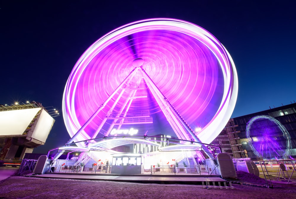 a ferris wheel is lit up at night