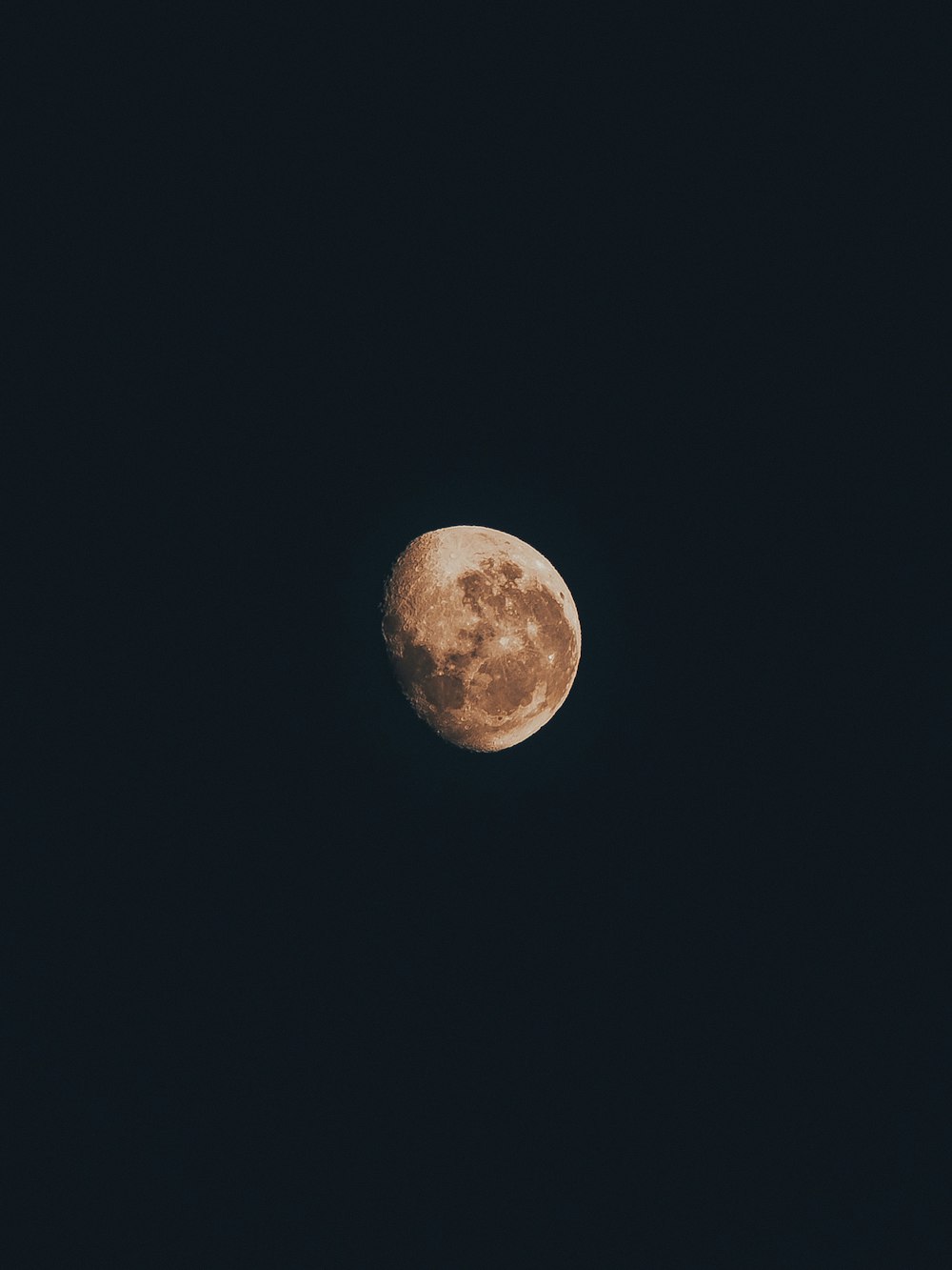 a full moon is seen in the dark sky