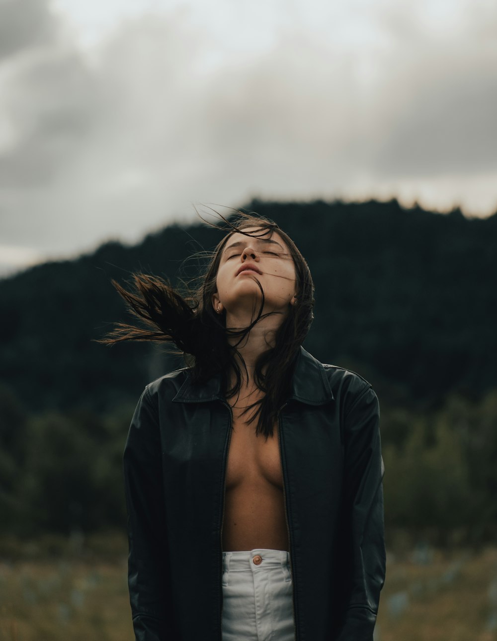 a woman with her hair blowing in the wind