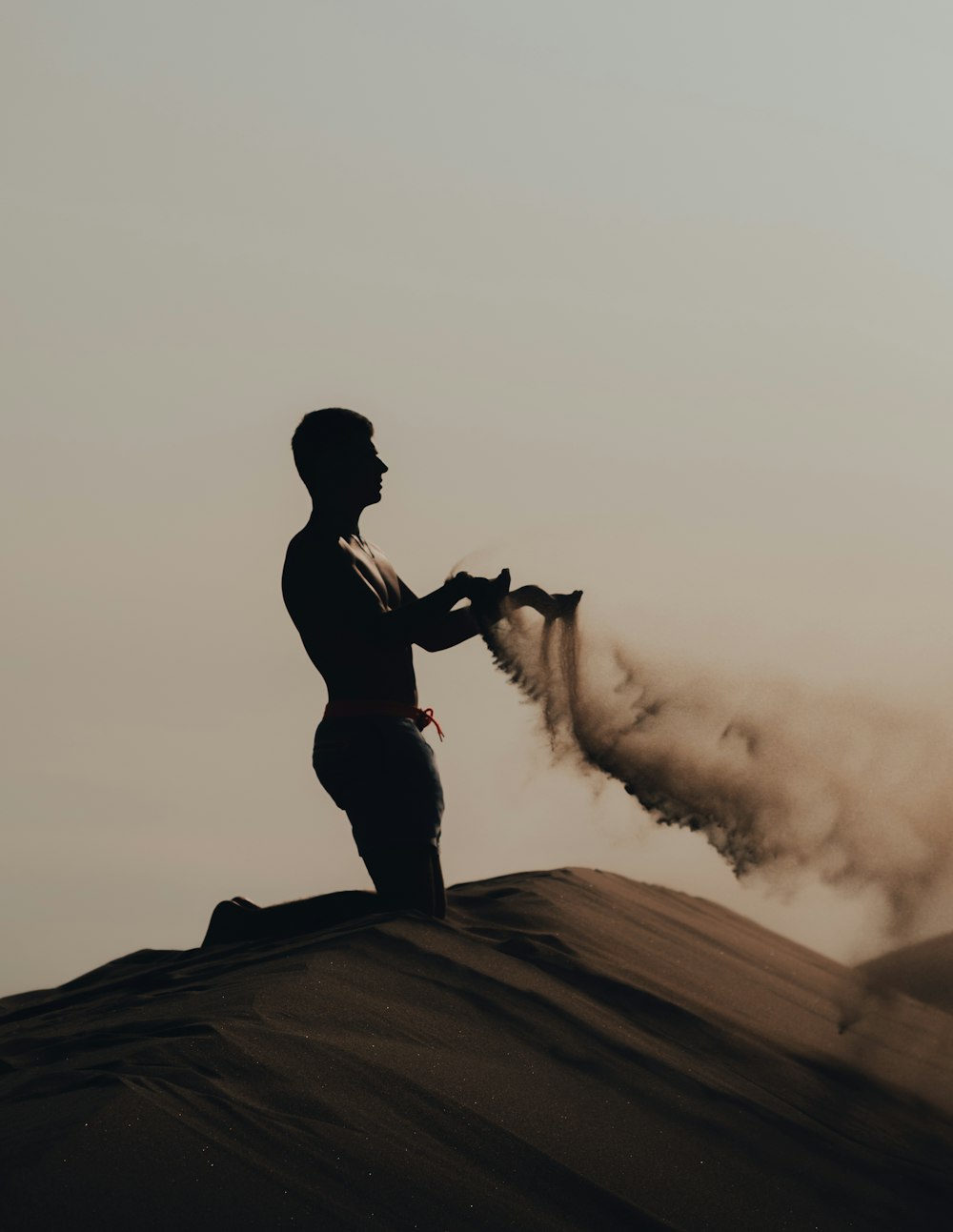 a person standing on top of a sand dune