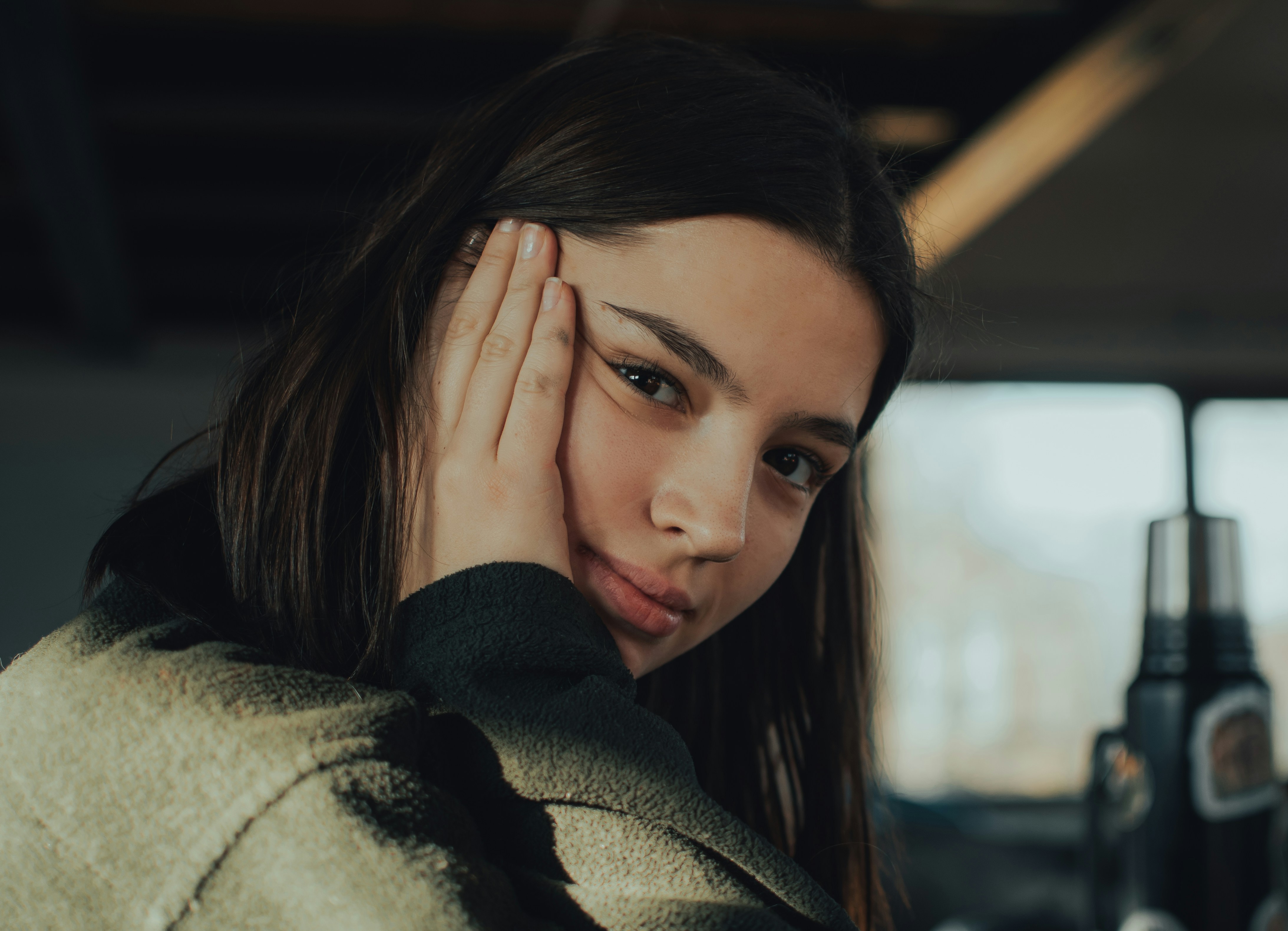 a woman holding her hand to her face