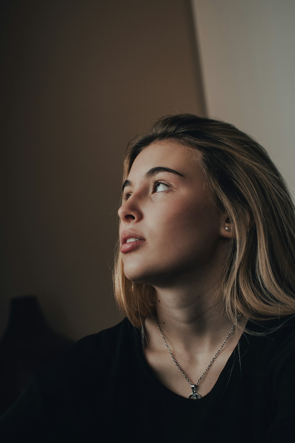 a woman wearing a black shirt and a necklace