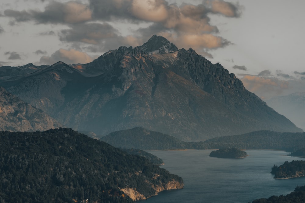 a mountain range with a lake in the foreground