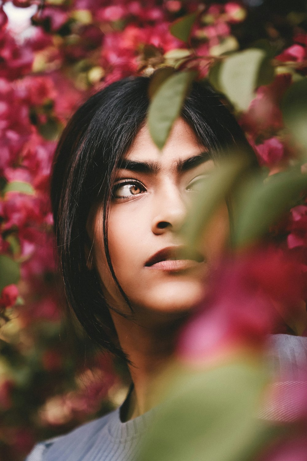 a young woman is staring into the distance