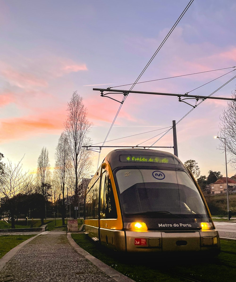 a yellow and black train traveling down train tracks