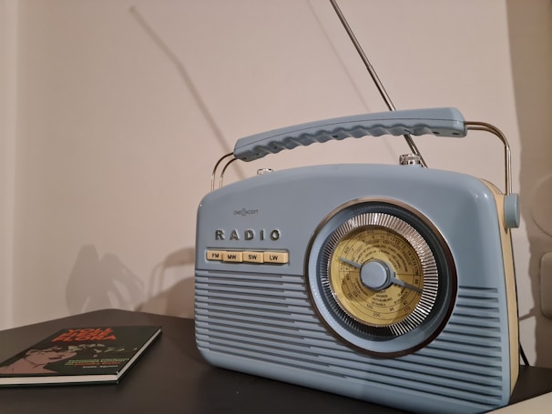 a radio sitting on top of a table next to a book