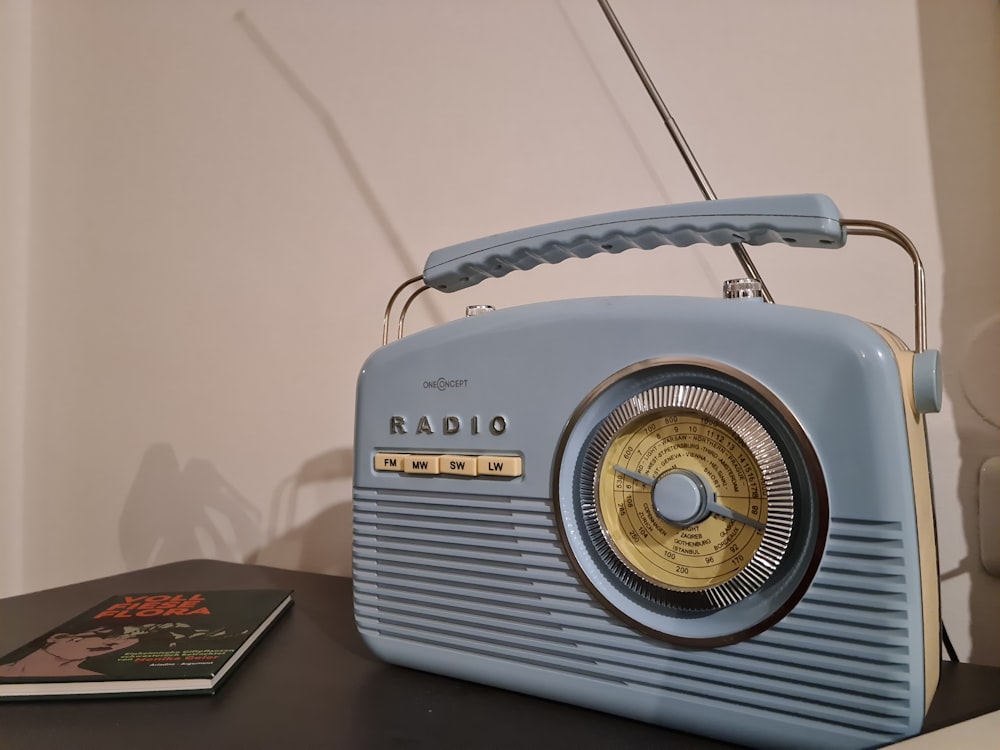 a radio sitting on top of a table next to a book