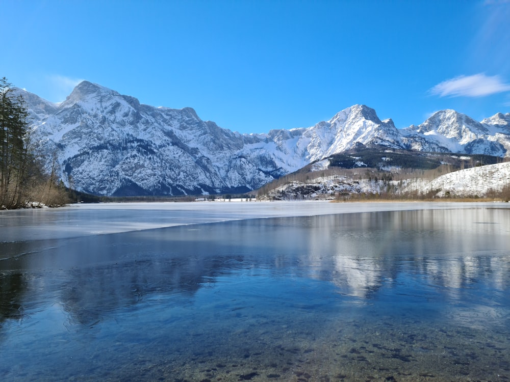 a body of water with mountains in the background