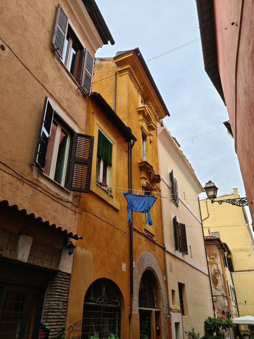 a building with a blue umbrella hanging from it's side