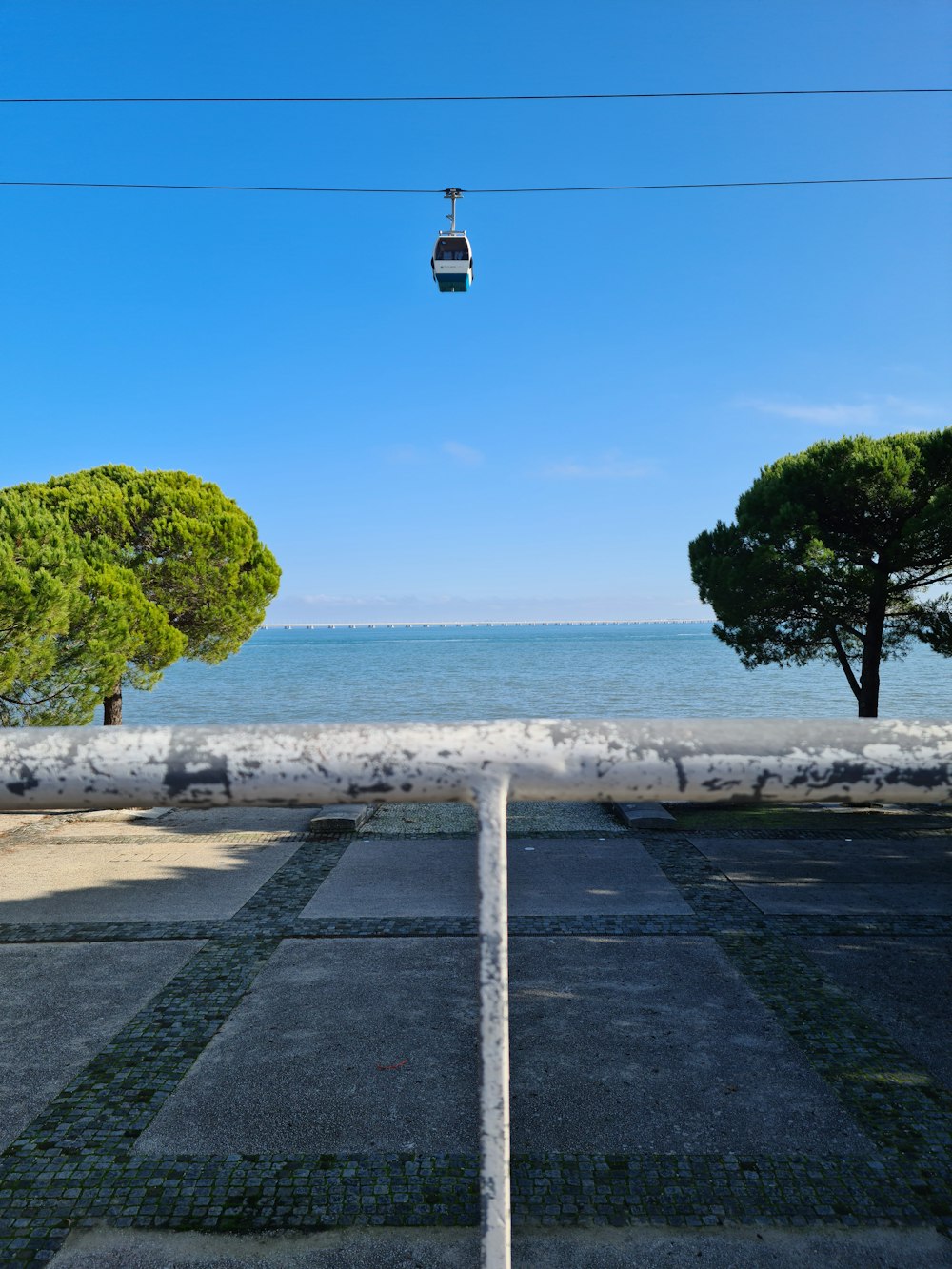 an empty parking lot next to the ocean