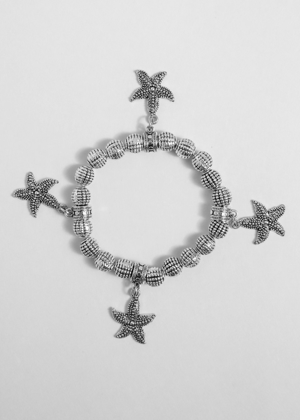 a bracelet with a starfish charm on it