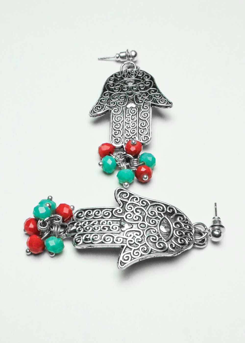 a necklace with a bird and beads on it