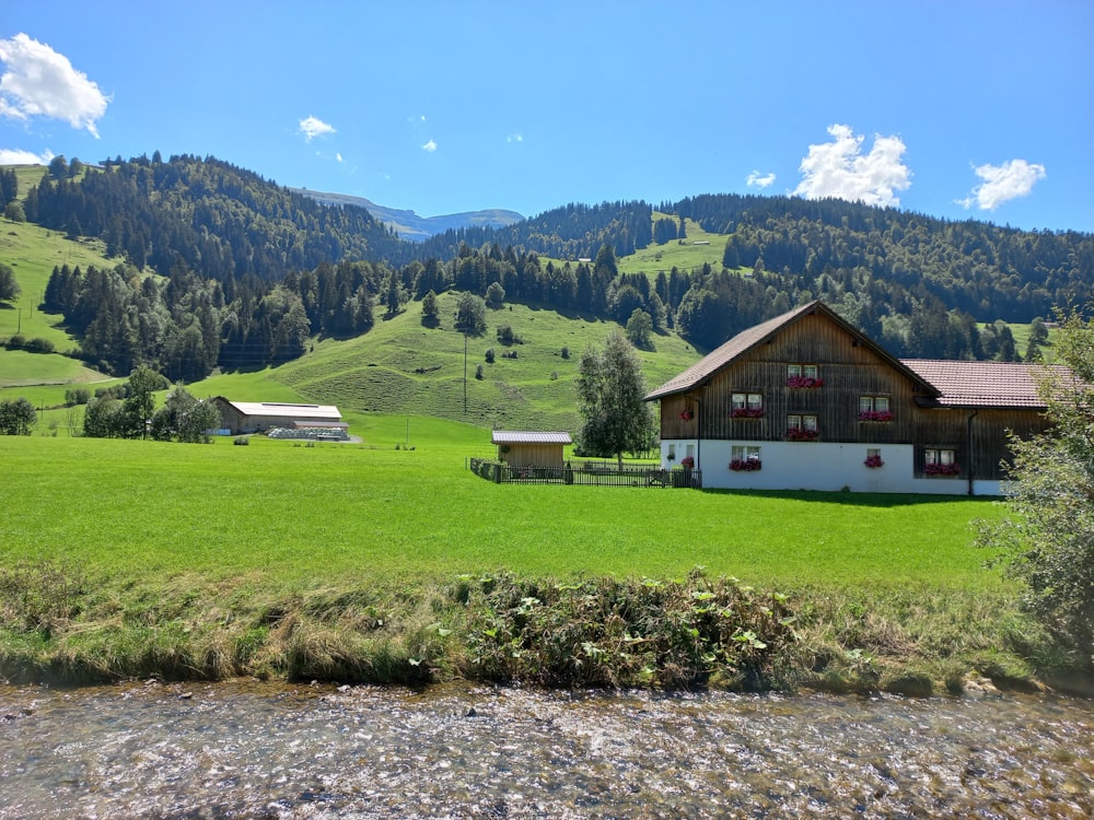 a house in a field with mountains in the background