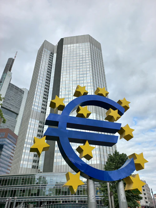 A large blue and yellow euro sign sculpture