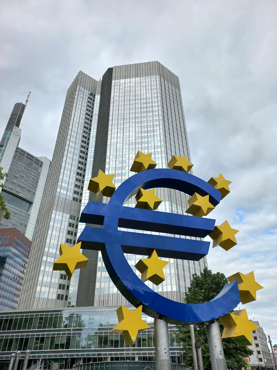 A large blue and yellow euro sign sculpture