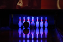 a bowling alley with bowling pins and a bowling ball