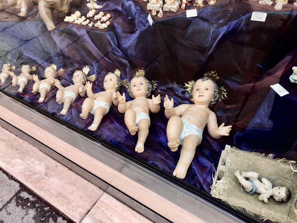 a display case filled with baby dolls in diapers