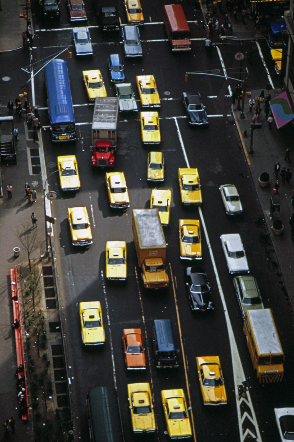 a street filled with lots of traffic next to tall buildings