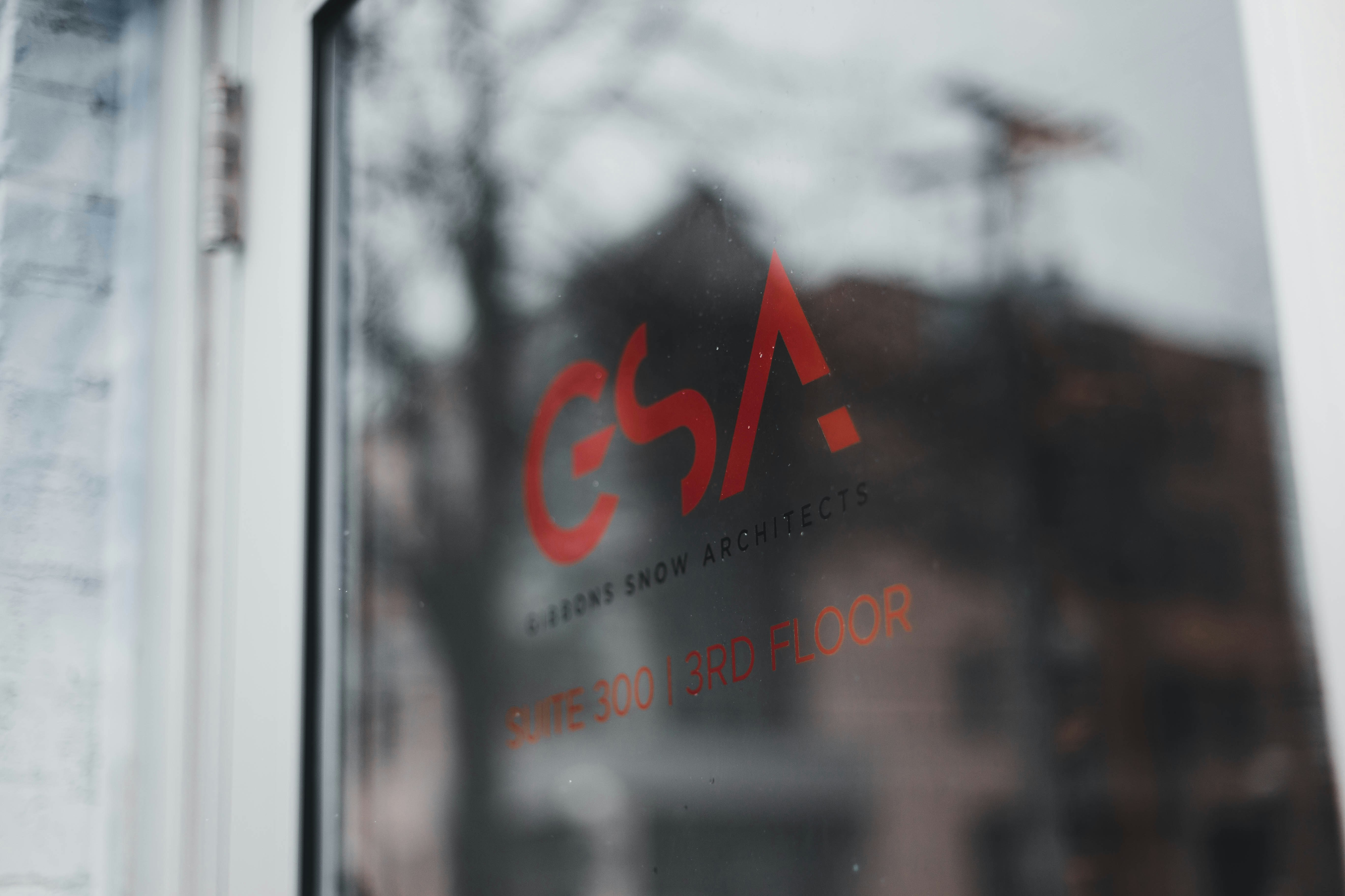 a close up of a window with a building in the background