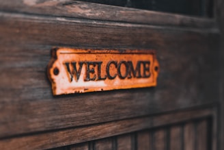 a close up of a welcome sign on a wooden door