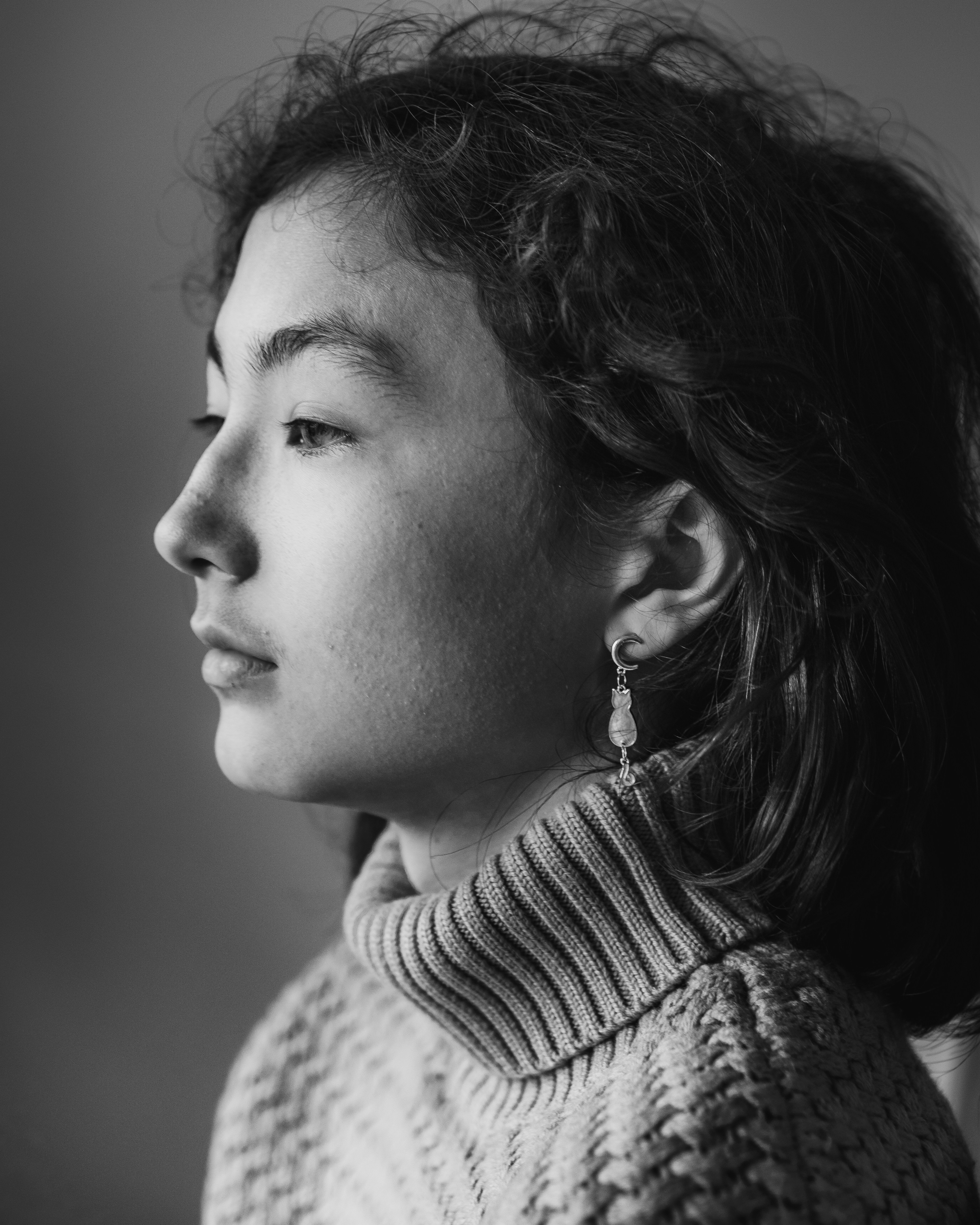 a black and white photo of a woman wearing a sweater