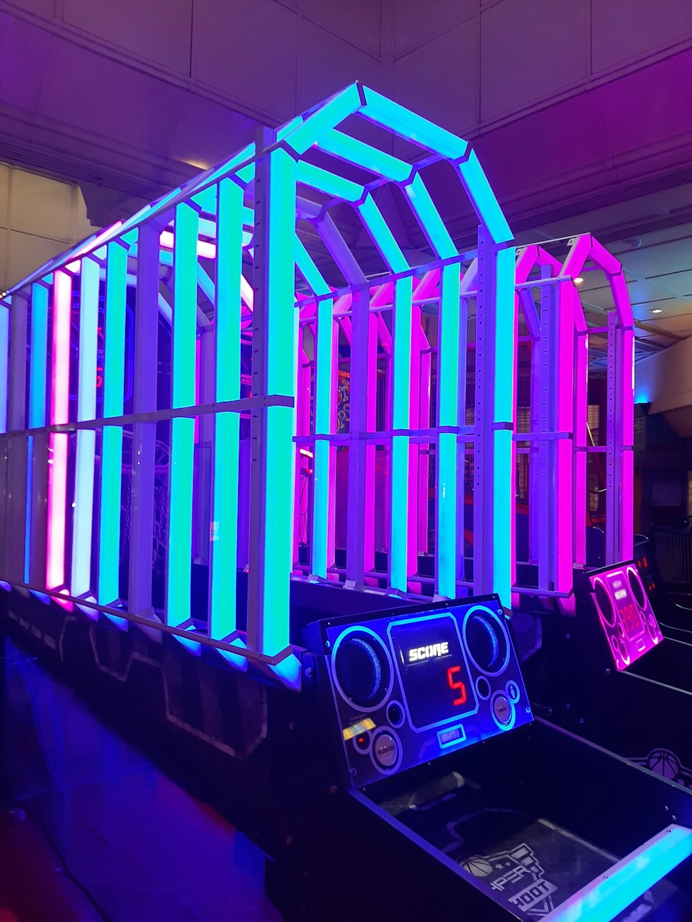 an arcade machine with neon lights on it