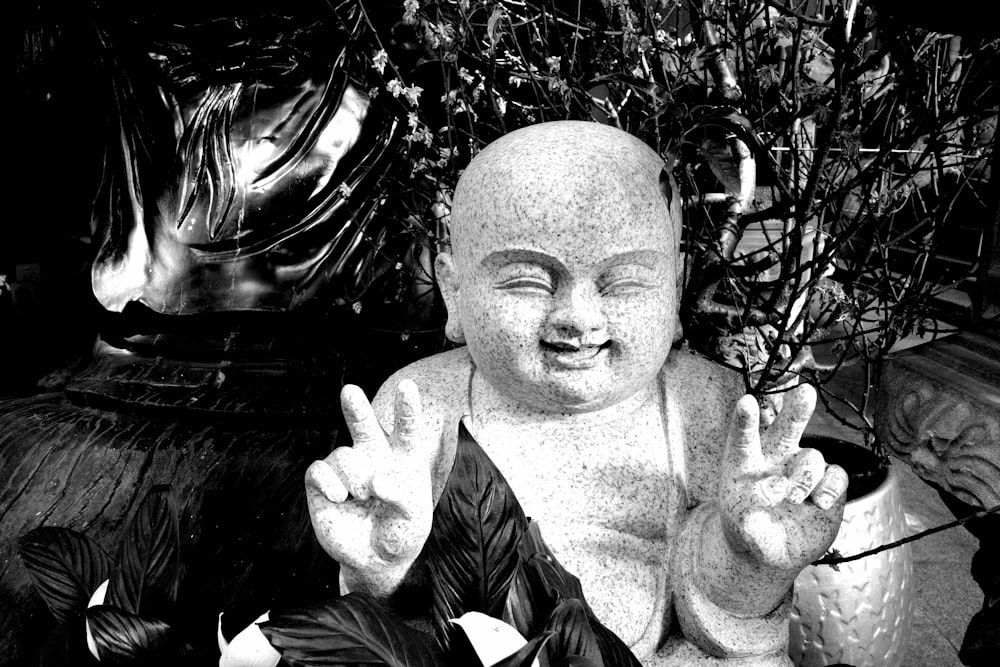 a black and white photo of a buddha statue