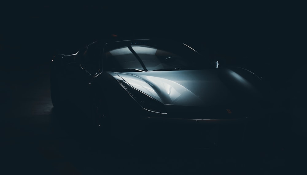 a black sports car in a dark room