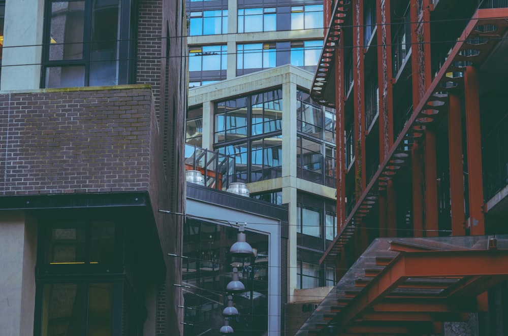 a red fire hydrant sitting next to a tall building