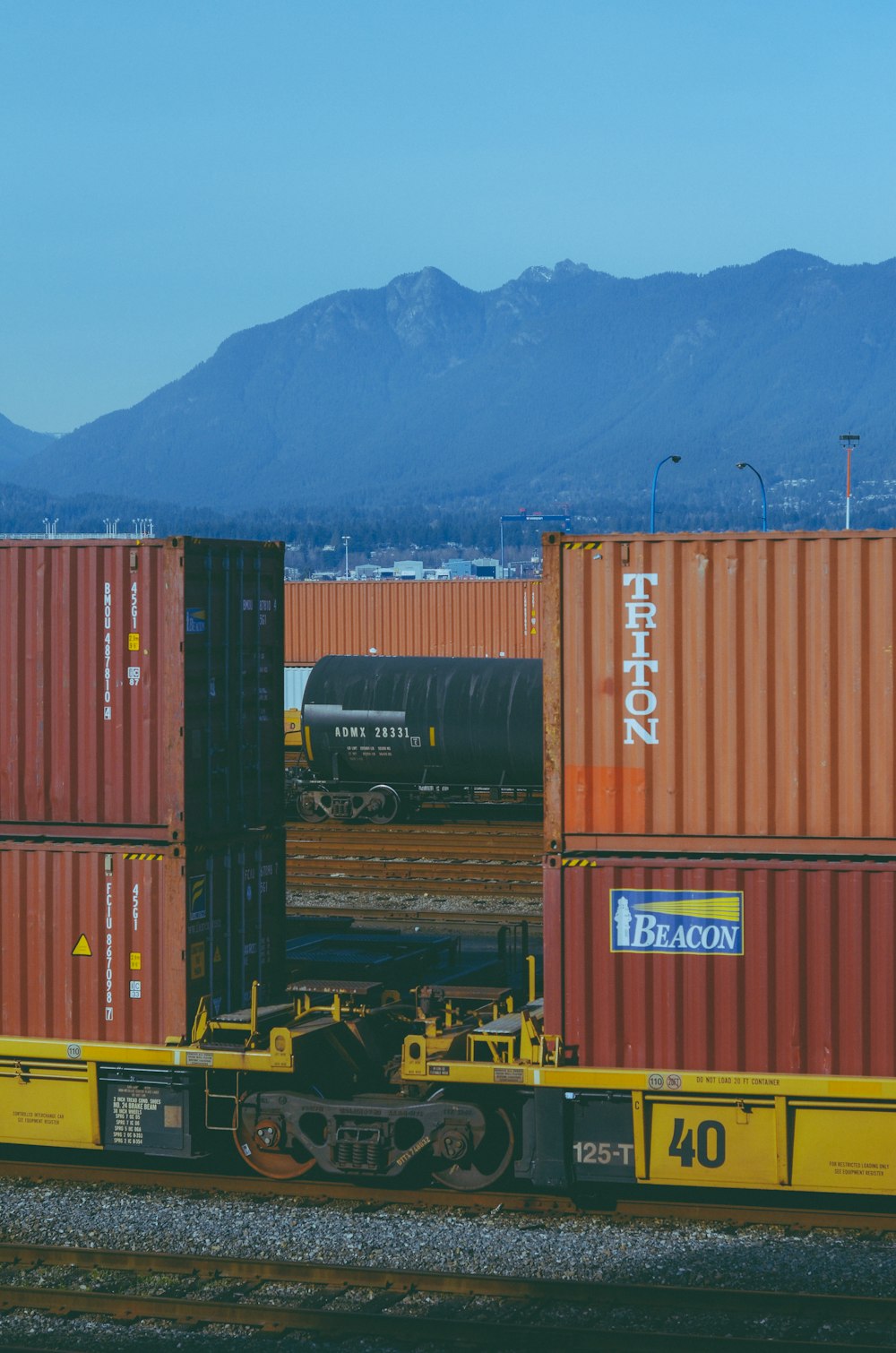 a train with a bunch of containers on the back of it