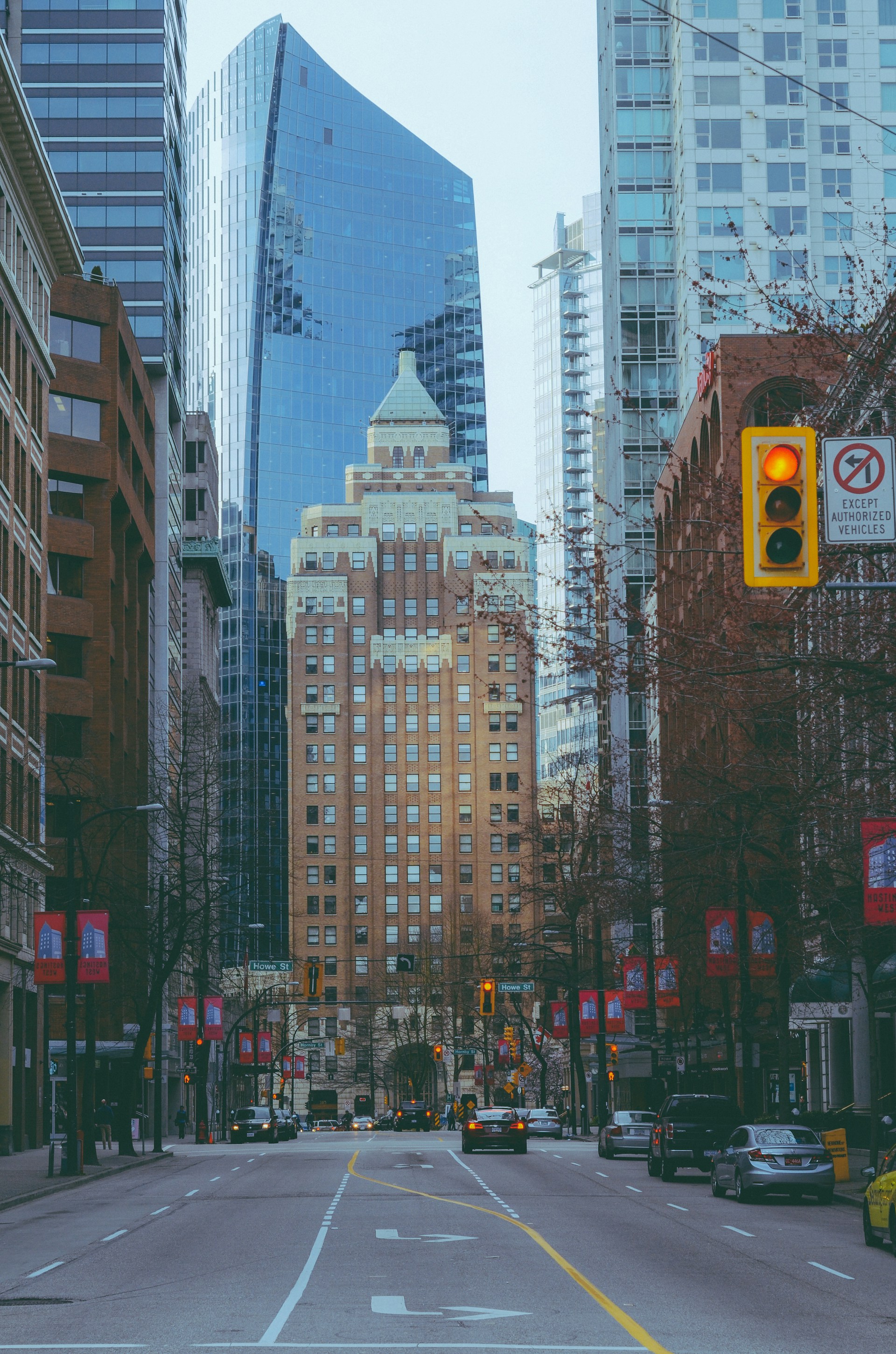 a city street with tall buildings and a traffic light