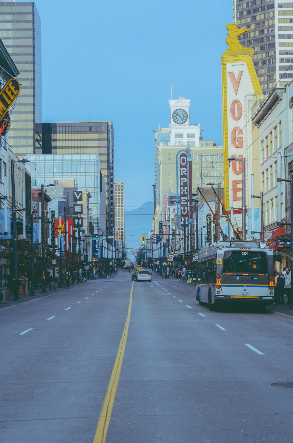 a city street lined with tall buildings and traffic