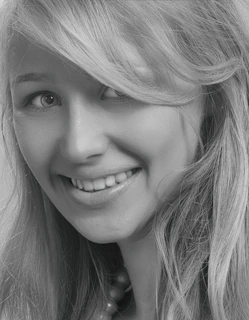 Close-up of a friendly female facilitator with a confident, approachable expression