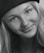 A professional headshot of a satisfied customer, Sarah J., smiling.