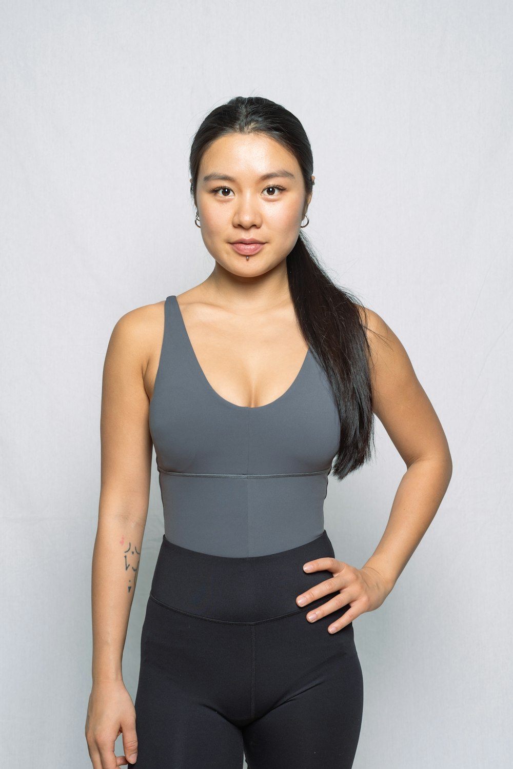 a woman posing for a picture in a gray top